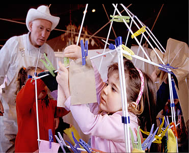 Sasha looks on as children play